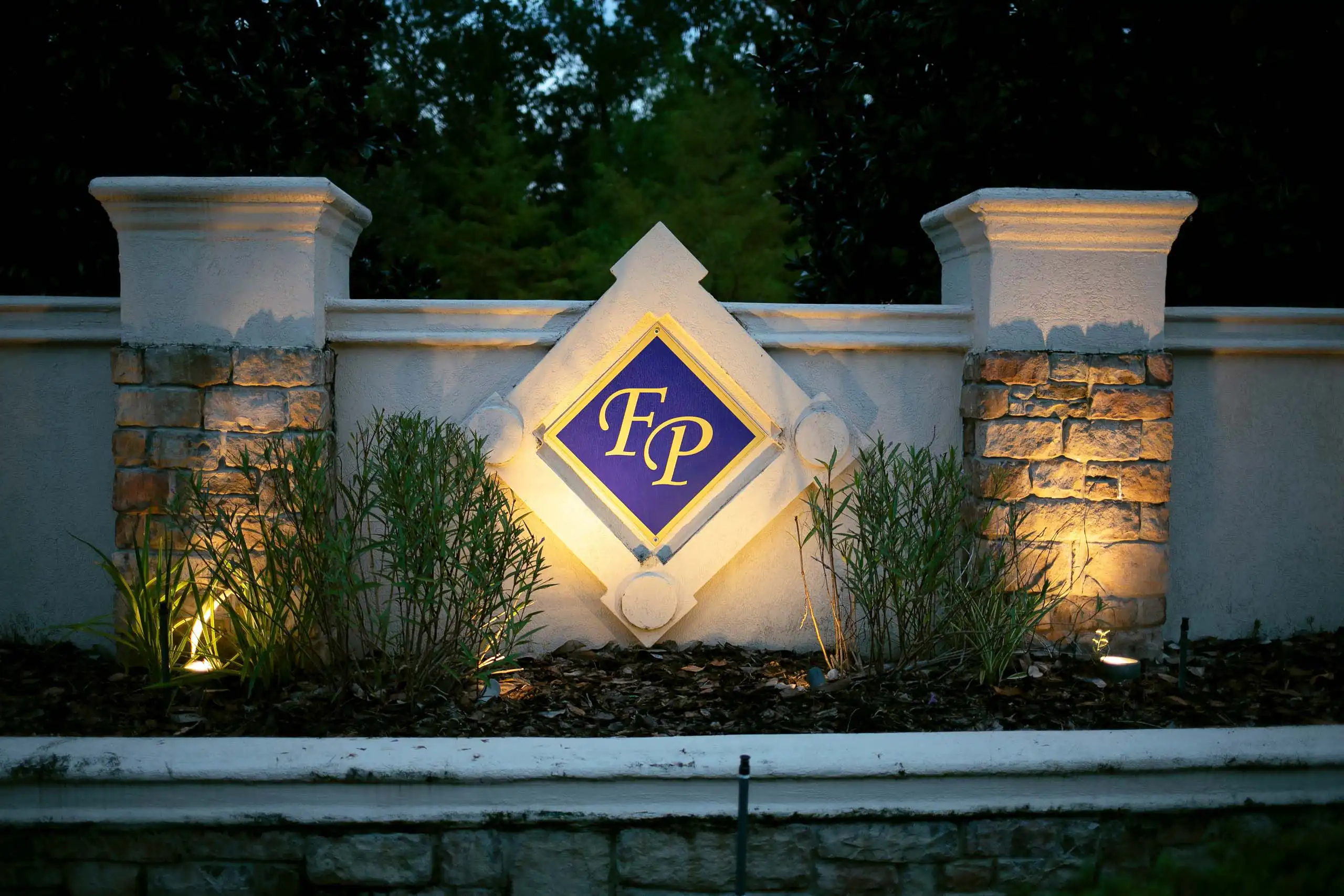 Outdoor living space ideas using lighting to highlight important signage.