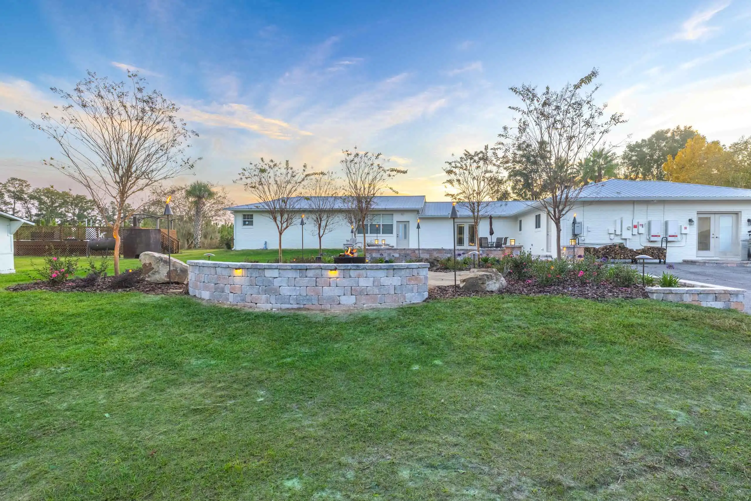 A backyard with a stone retaining wall