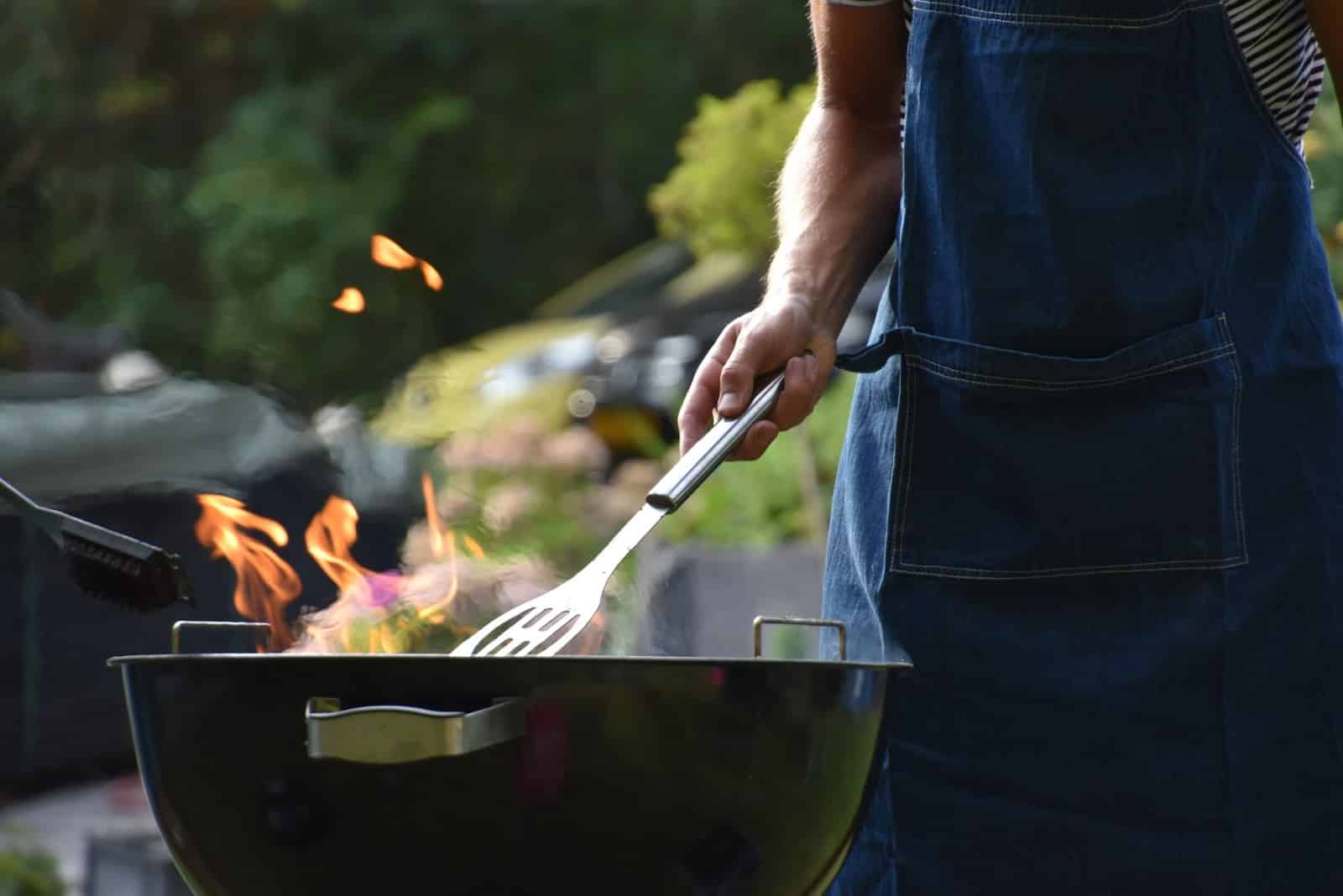 A man enjoying an outdoor grill.