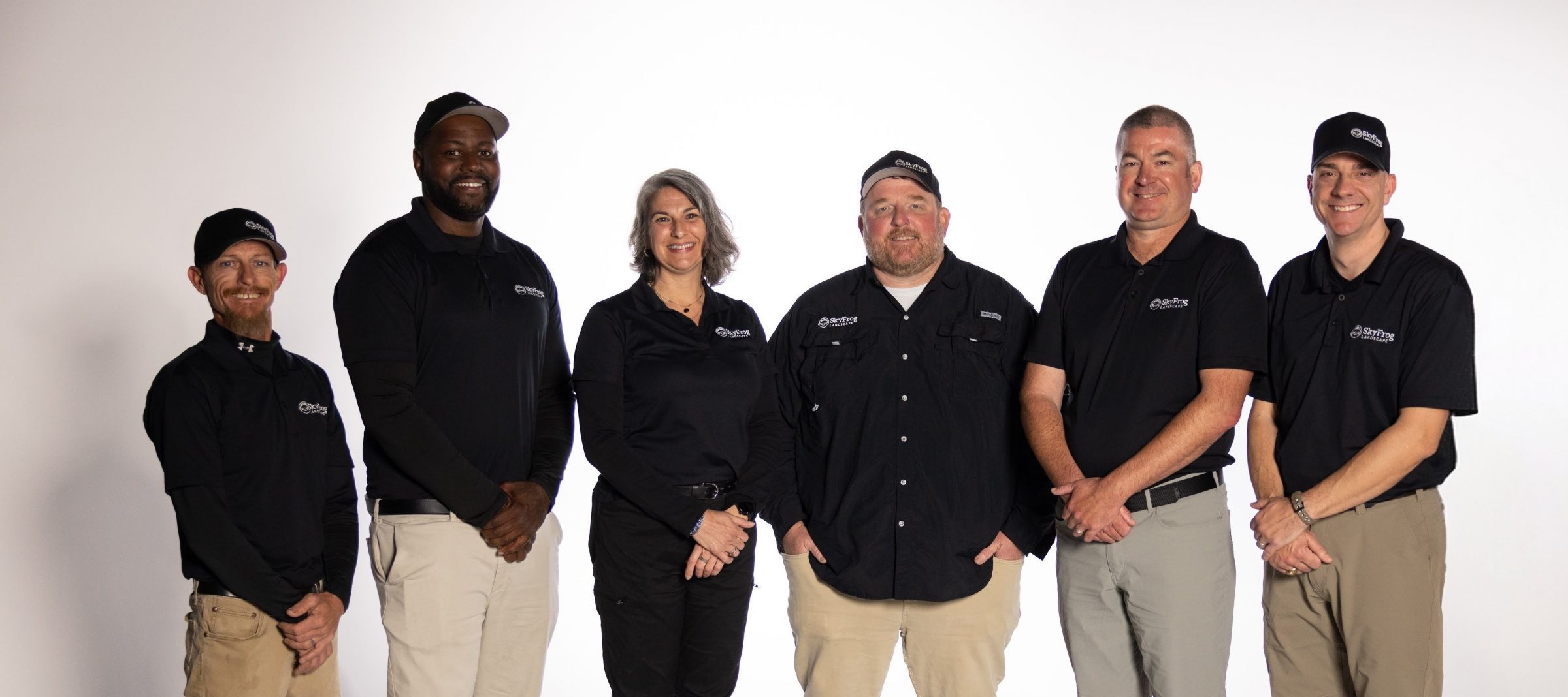 Six SkyFrog Landscape team members pose in uniform