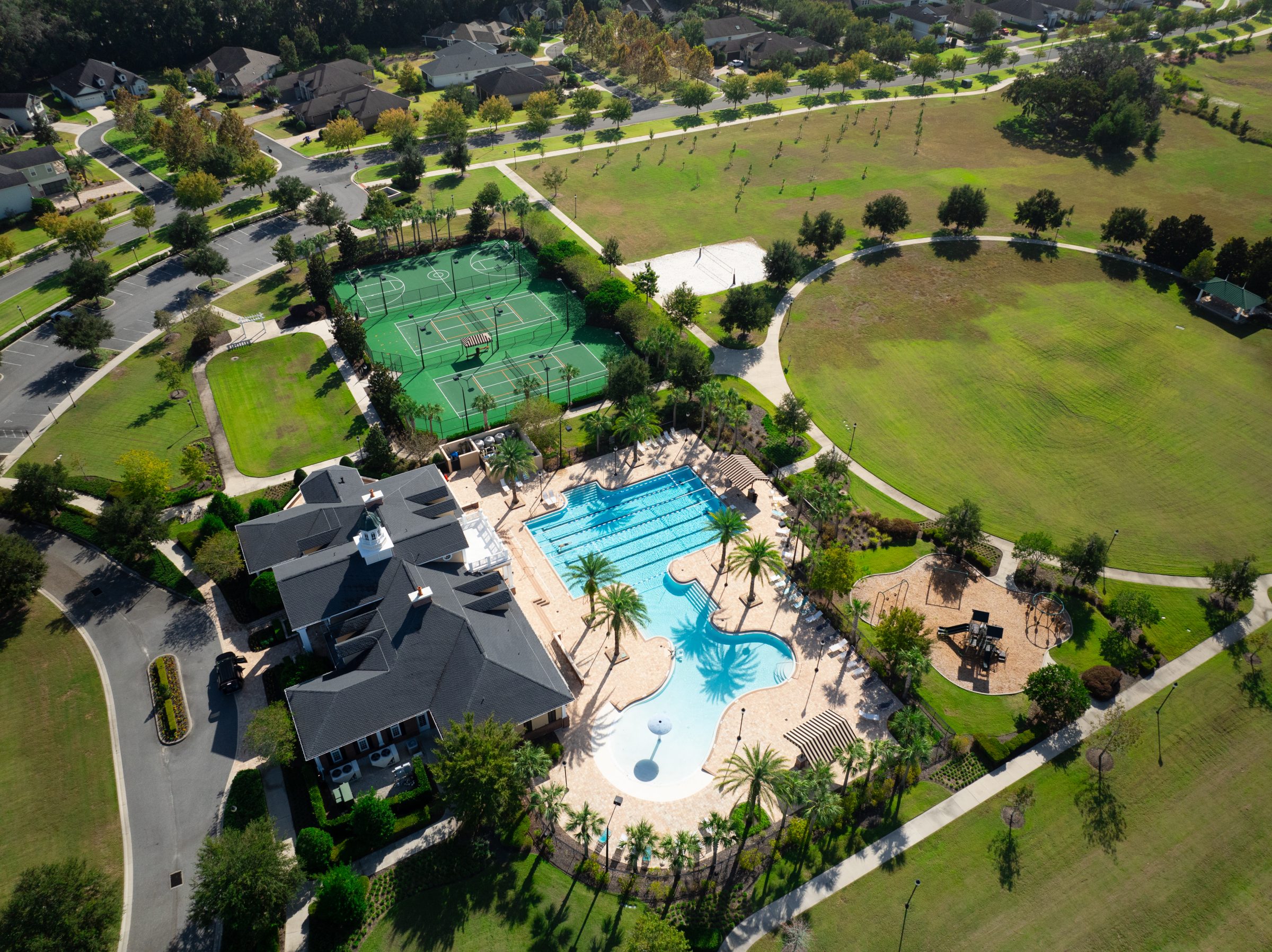 Aerial view of neighborhood pool, courts, and park