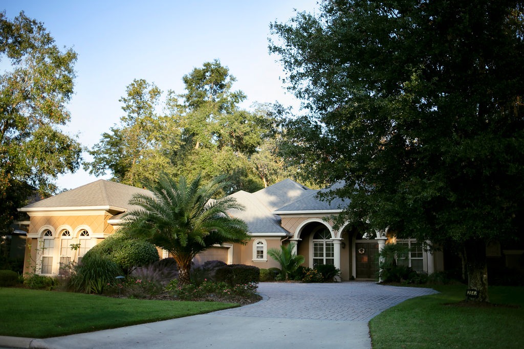 Elegant suburban home with palm tree and curved driveway
