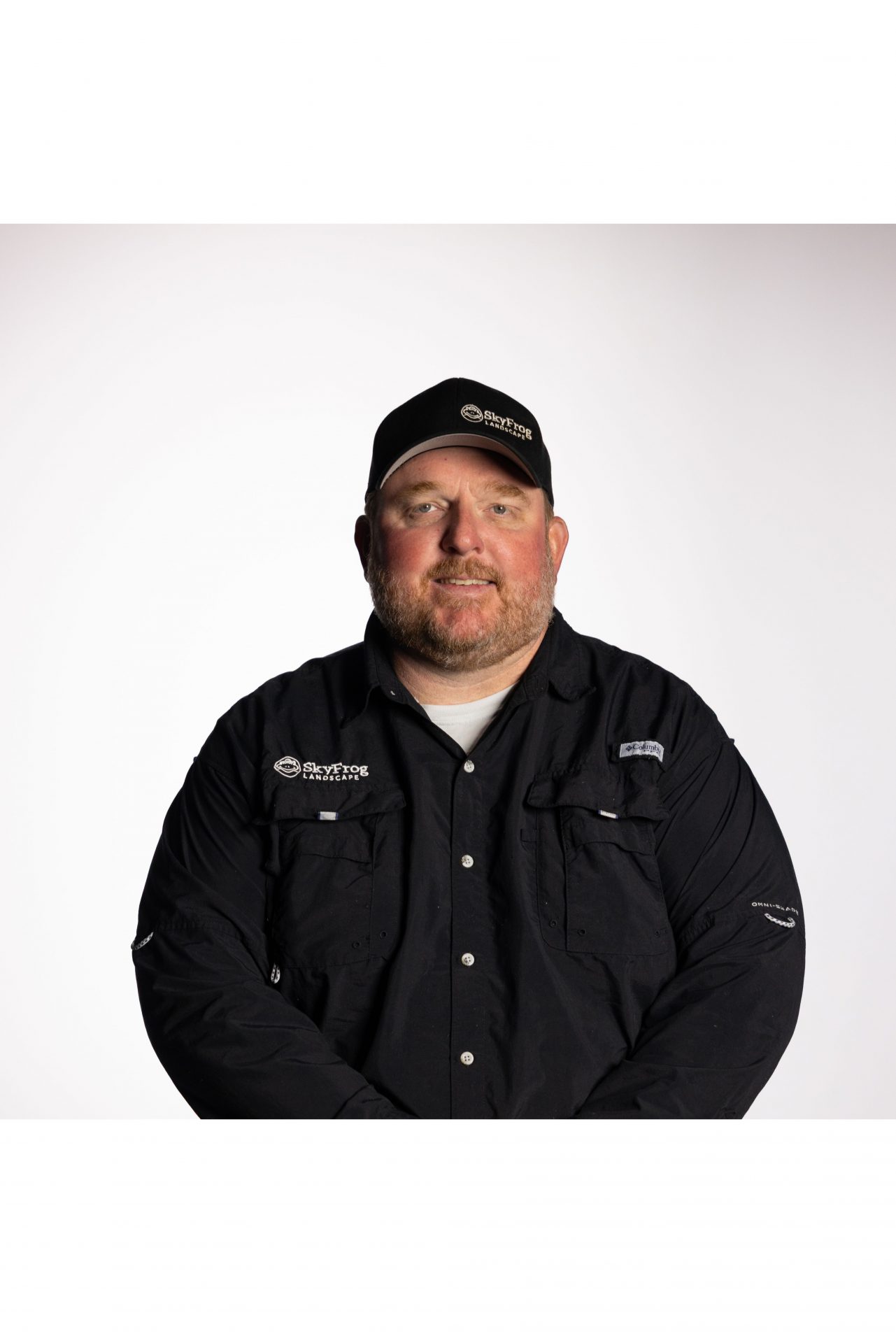 SkyFrog Landscapes employee in black uniform and cap