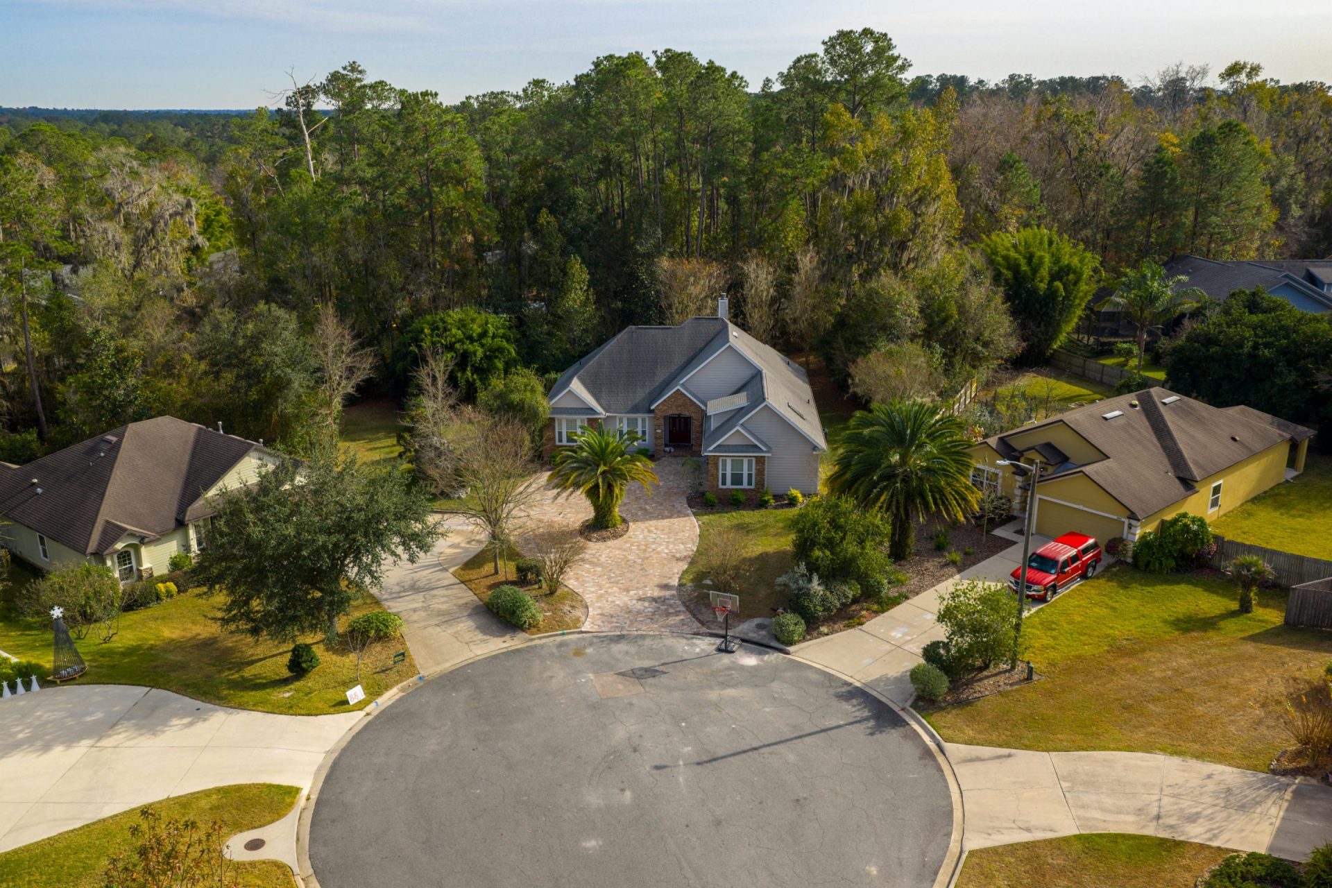 Aerial view of suburban homes beside wooded forest