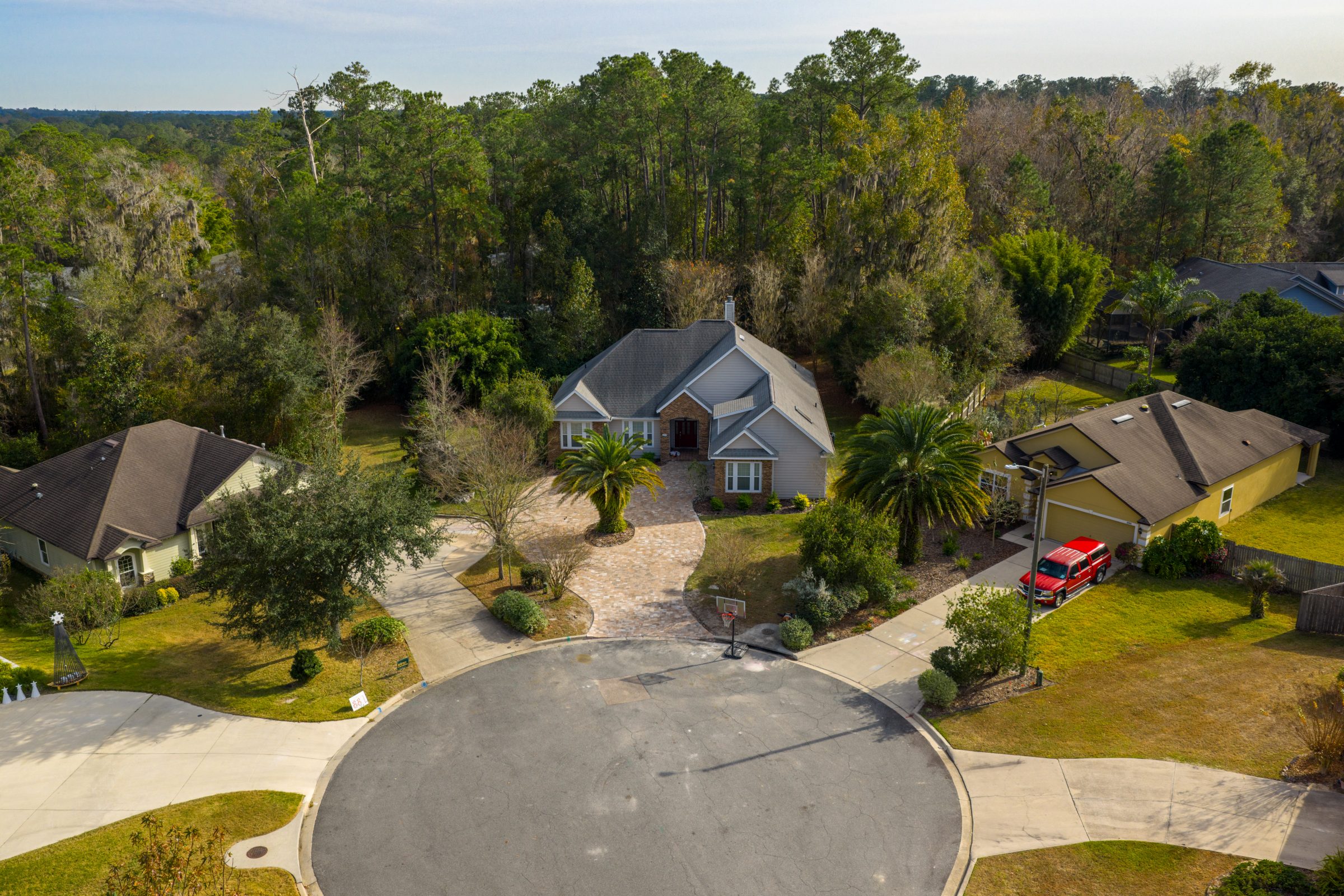Aerial view of homes bordering a wooded cul-de-sac