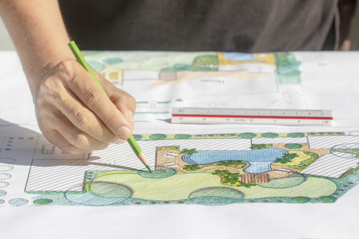 Designer coloring a detailed landscape garden plan