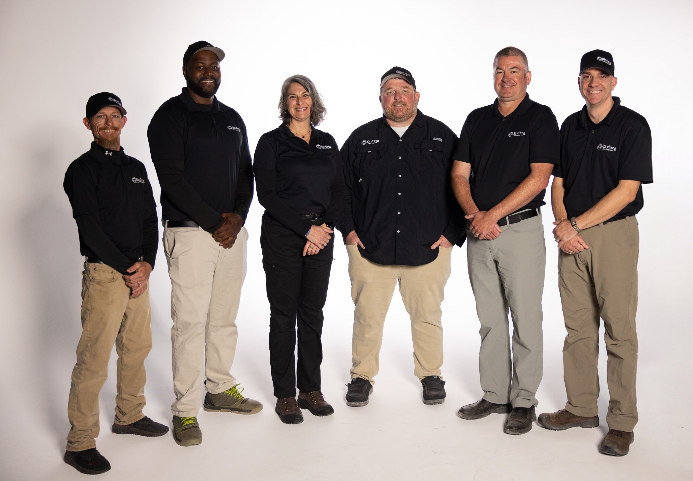 Six SkyFrog Landscape employees pose in matching uniforms.